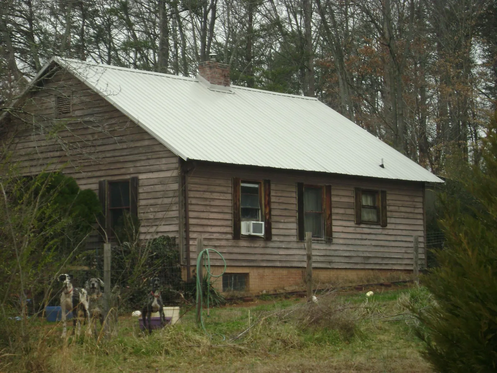 White metal roof on an old wood sided farmhouse, from a Metal Roof Installation job in Epsom